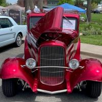 photo of red vehicle from car show