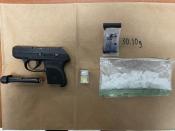 Photo of confiscated handgun and controlled substance