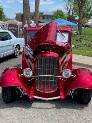 photo of red vehicle from car show